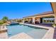 Beautiful backyard pool area with a covered patio and lush landscaping at 8298 W Agate Ave, Las Vegas, NV 89113