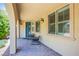 Cozy front porch with rocking chairs, tiled flooring, and elegant outdoor lighting at 8298 W Agate Ave, Las Vegas, NV 89113