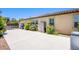 Spacious concrete side yard with ample storage and lush landscaping, providing privacy and functionality at 8298 W Agate Ave, Las Vegas, NV 89113