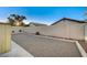 The backyard featuring a gravel area, block wall, and minimal landscaping offers a blank canvas for customization at 8412 Mulcahy Ave, Las Vegas, NV 89145