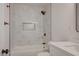 Updated bathroom with marble-tiled shower, modern fixtures, and a sleek vanity at 8412 Mulcahy Ave, Las Vegas, NV 89145