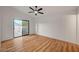 Bright bedroom features light wood flooring, a ceiling fan, and a sliding door leading to a private patio at 8412 Mulcahy Ave, Las Vegas, NV 89145