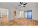 Open bedroom with light wood flooring, a ceiling fan, access to walk-in closet, and a glass sliding door at 8412 Mulcahy Ave, Las Vegas, NV 89145