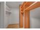 Walk-in closet with built-in shelving and wooden accents providing ample storage space at 8412 Mulcahy Ave, Las Vegas, NV 89145