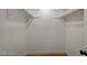 A basic walk-in closet with white shelving and light-colored wood-look flooring at 8412 Mulcahy Ave, Las Vegas, NV 89145