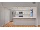 Modern kitchen with white cabinets, stainless steel appliances, and a breakfast bar at 8412 Mulcahy Ave, Las Vegas, NV 89145