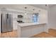 Modern kitchen with white cabinets, stainless steel appliances, and a breakfast bar at 8412 Mulcahy Ave, Las Vegas, NV 89145