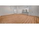 Open living area with wood floors flows into the updated kitchen and features recessed lighting and neutral tones at 8412 Mulcahy Ave, Las Vegas, NV 89145