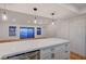 Open-concept living space with wood floors, recessed lighting, and sliding glass doors to the outdoors at 8412 Mulcahy Ave, Las Vegas, NV 89145