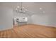 Spacious living room featuring modern lighting, wood floors, and an open floor plan to the kitchen at 8412 Mulcahy Ave, Las Vegas, NV 89145