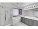 Bright bathroom featuring double sinks, bathtub, and glass-enclosed shower at 8529 Gold Flash Ave, Las Vegas, NV 89129