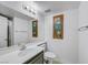 Bathroom featuring a single sink vanity and framed botanical artwork at 8529 Gold Flash Ave, Las Vegas, NV 89129