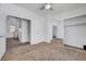 Carpeted bedroom featuring a ceiling fan and a closet with mirrored sliding doors at 8529 Gold Flash Ave, Las Vegas, NV 89129