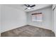 Bedroom with a ceiling fan, white walls, and brown carpet at 8529 Gold Flash Ave, Las Vegas, NV 89129