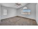 Bedroom with two windows, neutral carpet and white walls at 8529 Gold Flash Ave, Las Vegas, NV 89129