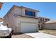 View of a charming two-story home with a spacious two-car garage and desert landscaping at 8529 Gold Flash Ave, Las Vegas, NV 89129