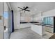 Open kitchen features white cabinets, stainless appliances, and sliding door to backyard at 8529 Gold Flash Ave, Las Vegas, NV 89129