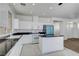 Well-lit kitchen featuring white cabinets, granite counters, stainless-steel appliances, and tiled flooring at 8529 Gold Flash Ave, Las Vegas, NV 89129
