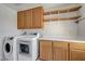 A laundry room with a washer, dryer, upper cabinets, a countertop, and lower cabinets for storage at 8529 Gold Flash Ave, Las Vegas, NV 89129
