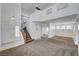 Bright living room featuring two-story ceilings, stairs, and neutral carpeting at 8529 Gold Flash Ave, Las Vegas, NV 89129
