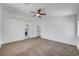 Spacious main bedroom with carpet, ceiling fan, and multiple doors at 8529 Gold Flash Ave, Las Vegas, NV 89129