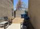 Small backyard with gravel, patio, trash cans, and metal outdoor furniture at 8898 Promised Land Ave, Las Vegas, NV 89148
