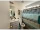 Updated bathroom featuring a modern vanity, toilet, and shower with decorative curtain at 8898 Promised Land Ave, Las Vegas, NV 89148