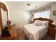Comfortable bedroom with carpet, wood furniture, and a double bed with decorative pillows at 8898 Promised Land Ave, Las Vegas, NV 89148