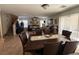 Open dining area with a large table, tile flooring, and a view of the living room at 8898 Promised Land Ave, Las Vegas, NV 89148