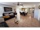 Open concept living area featuring tile flooring, comfortable seating, and a dining space at 8898 Promised Land Ave, Las Vegas, NV 89148