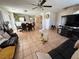 Spacious living room with neutral tile flooring, comfortable seating, and a ceiling fan at 8898 Promised Land Ave, Las Vegas, NV 89148