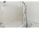 Bathroom with white tiled walls and a shower and tub combination at 9116 Cypress Point Way, Las Vegas, NV 89117