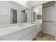 Well-lit bathroom featuring a large mirror, vanity, and a closet with mirrored doors at 9116 Cypress Point Way, Las Vegas, NV 89117