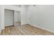 Bedroom with new wood-look flooring and a closet with mirrored doors at 9116 Cypress Point Way, Las Vegas, NV 89117