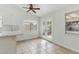 Dining area with ceiling fan, white walls, tile flooring, and backyard access at 9116 Cypress Point Way, Las Vegas, NV 89117