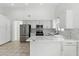Modern kitchen features stainless steel appliances, white cabinetry, and a stylish backsplash, with ample counter space at 9116 Cypress Point Way, Las Vegas, NV 89117