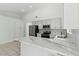 Modern kitchen features stainless steel appliances, white cabinetry, and a stylish backsplash, with ample counter space at 9116 Cypress Point Way, Las Vegas, NV 89117