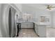 Bright kitchen with white cabinetry, stainless steel appliances, marble countertops, and tile flooring at 9116 Cypress Point Way, Las Vegas, NV 89117