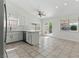 Bright kitchen features white cabinets, marble countertops, and a view to the dining area at 9116 Cypress Point Way, Las Vegas, NV 89117