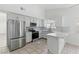 Bright kitchen with stainless steel appliances, marble countertops, tile backsplash, and tile flooring at 9116 Cypress Point Way, Las Vegas, NV 89117