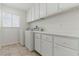 Functional laundry room with washer, dryer, cabinets and window for natural light at 9116 Cypress Point Way, Las Vegas, NV 89117