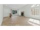 Bright living room with tile flooring, a fireplace, and large windows at 9116 Cypress Point Way, Las Vegas, NV 89117