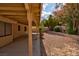 Relaxing covered patio opening to a low-maintenance gravel backyard with privacy landscaping at 9116 Cypress Point Way, Las Vegas, NV 89117