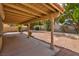 Wide covered patio opening to a low-maintenance yard with mature landscaping and privacy wall at 9116 Cypress Point Way, Las Vegas, NV 89117