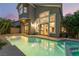 A gorgeous home featuring a private pool and spa with large glass windows and sliding glass doors overlooking the backyard at 912 Pro Players Dr, Las Vegas, NV 89134