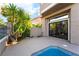 Exterior patio area featuring a partial view of the pool, greenery and desert landscaping at 912 Pro Players Dr, Las Vegas, NV 89134