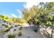 Beautiful backyard featuring mature trees and walking path at 912 Pro Players Dr, Las Vegas, NV 89134