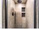 Modern tiled shower with black fixtures and built-in shelving for toiletries offers a luxurious experience at 912 Pro Players Dr, Las Vegas, NV 89134