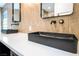 Close up on bathroom's dual sinks, wall-mounted faucets, and white countertop at 912 Pro Players Dr, Las Vegas, NV 89134