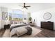Comfortable bedroom with large windows, wood floors, and neutral decor offers a relaxing retreat at 912 Pro Players Dr, Las Vegas, NV 89134